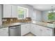 Kitchen sink features stainless appliances and granite countertops at 8014 Sherington Way, Charlotte, NC 28227