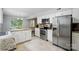 Updated kitchen with stainless appliances, island, and adjoining breakfast nook area at 8014 Sherington Way, Charlotte, NC 28227