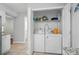 Bright laundry room with white washer and dryer inside the house at 8014 Sherington Way, Charlotte, NC 28227