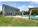 Spacious backyard with a pool, patio, seating area, and well-maintained lawn at 837 Tyne Dr, Fort Mill, SC 29715