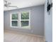 Well-lit bedroom featuring two windows with blinds and a ceiling fan at 837 Tyne Dr, Fort Mill, SC 29715