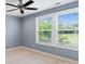 Bright bedroom with neutral paint, plush carpet, and double hung windows at 837 Tyne Dr, Fort Mill, SC 29715