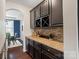 Butler's pantry with dark cabinetry, granite counters, and wine storage at 837 Tyne Dr, Fort Mill, SC 29715