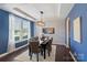 Elegant dining room featuring a modern light fixture, large window, and stylish wallpaper at 837 Tyne Dr, Fort Mill, SC 29715