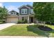 Charming two-story home featuring a manicured lawn, brick accents, and a two-car garage at 837 Tyne Dr, Fort Mill, SC 29715