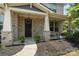 Inviting front porch with a black door, gray brick facade, white columns, and manicured landscaping at 837 Tyne Dr, Fort Mill, SC 29715
