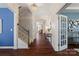 Inviting hallway with hardwood floors, staircase, chandelier and convenient access to rooms at 837 Tyne Dr, Fort Mill, SC 29715