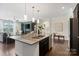 Open-concept kitchen with island, granite countertops, stainless steel appliances, and seamless flow to living area at 837 Tyne Dr, Fort Mill, SC 29715
