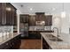Spacious kitchen featuring dark wood cabinetry, stainless appliances, and granite countertops at 837 Tyne Dr, Fort Mill, SC 29715