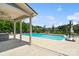 Backyard features a sparkling in-ground pool, covered patio, and lounge area at 837 Tyne Dr, Fort Mill, SC 29715
