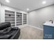 Cozy basement featuring built-in shelving and a leather chair at 8527 Foxbridge Dr, Matthews, NC 28104