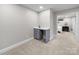 Basement featuring a wet bar with a sink and a view of the bedroom at 8527 Foxbridge Dr, Matthews, NC 28104