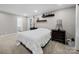 Cozy bedroom with neutral tones, plush carpeting, two bedside tables, and a view to the ensuite bathroom at 8527 Foxbridge Dr, Matthews, NC 28104