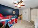 Playful ' bedroom with ceiling fan, dark accent wall, and twin size bunk bed at 8527 Foxbridge Dr, Matthews, NC 28104