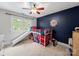 A fun bedroom with bunk bed, slide and a target game on a blue accent wall at 8527 Foxbridge Dr, Matthews, NC 28104