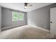 Empty bedroom showcasing a ceiling fan and a window at 8527 Foxbridge Dr, Matthews, NC 28104