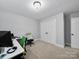 Bedroom with neutral paint, carpet and fixtures that has a closet to the right of the image at 8527 Foxbridge Dr, Matthews, NC 28104