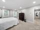 Spacious bedroom with carpet flooring and natural light from multiple windows at 8527 Foxbridge Dr, Matthews, NC 28104