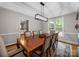 Elegant dining room featuring a wooden table, upholstered chairs, and stylish lighting at 8527 Foxbridge Dr, Matthews, NC 28104