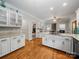 Spacious kitchen with white cabinets, quartz countertops, stainless steel appliances, and hardwood floors at 8527 Foxbridge Dr, Matthews, NC 28104