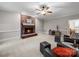 Inviting living room with a brick fireplace, neutral tones, and a ceiling fan at 8527 Foxbridge Dr, Matthews, NC 28104