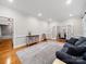 Open living room featuring hardwood floors, a neutral palette, and access to the dining area through French doors at 8527 Foxbridge Dr, Matthews, NC 28104