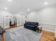 Bright living room with hardwood floors, a cozy couch, and French doors to a dining area at 8527 Foxbridge Dr, Matthews, NC 28104