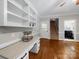 Bright office space with built-in shelves, hardwood floors, and an exterior door at 8527 Foxbridge Dr, Matthews, NC 28104