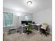 Bright office space featuring multiple monitors, a comfortable workspace, and natural light from two windows at 8527 Foxbridge Dr, Matthews, NC 28104