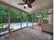 Inviting screened porch with ceiling fan overlooking the sparkling pool and lush backyard at 8527 Foxbridge Dr, Matthews, NC 28104
