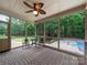 Screened-in porch that includes views of the pool, and the well-manicured back yard at 8527 Foxbridge Dr, Matthews, NC 28104