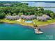 Stunning aerial view of waterfront condos, a community pool, boat docks, and the beautiful Lake Norman at 930 Jetton St, Davidson, NC 28036