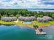 Expansive aerial view of waterfront condos with a pool and boat docks, set against a backdrop of serene lake and trees at 930 Jetton St, Davidson, NC 28036
