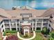 Top-down view of an apartment building with a well-manicured lawn, beautiful landscaping, and a lakeside dock at 930 Jetton St, Davidson, NC 28036