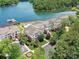 Expansive aerial view featuring lakeside condos, a swimming pool, ample parking, and stunning lake views at 930 Jetton St, Davidson, NC 28036