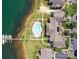 Detailed aerial view of waterfront condos featuring a pool, boat docks, parking areas, and manicured lawns at 930 Jetton St, Davidson, NC 28036