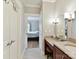 Bathroom features a sink, tiled floors and a doorway view of the bedroom at 930 Jetton St, Davidson, NC 28036