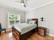 Inviting bedroom with a window, storage drawers under the bed, ceiling fan, and mounted bracket at 930 Jetton St, Davidson, NC 28036