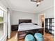 Well-lit bedroom with a ceiling fan, a large bed, and wood-look floors at 930 Jetton St, Davidson, NC 28036