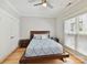 Cozy bedroom featuring a comfortable bed, ceiling fan, and natural light from the window at 930 Jetton St, Davidson, NC 28036