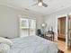 Bright bedroom with a window, ceiling fan, wood floors, and a view into a connected room at 930 Jetton St, Davidson, NC 28036