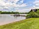 Lakeside view with a dock featuring several boats, surrounded by lush trees and blue skies at 930 Jetton St, Davidson, NC 28036