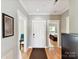 Inviting entryway with hardwood floors, white trim, and views into the dining room and bedroom at 930 Jetton St, Davidson, NC 28036