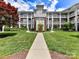 Beautiful condo building with a well-manicured lawn and a charming walkway leading to the entrance at 930 Jetton St, Davidson, NC 28036