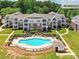 Beautiful condo building with a pool and outdoor seating in a well-maintained community, located at 930 Jetton St #25 at 930 Jetton St, Davidson, NC 28036