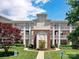 Apartment building with manicured front lawn, colorful landscaping, and reserved parking signs at 930 Jetton St, Davidson, NC 28036
