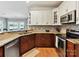 Well-appointed kitchen features granite counters, mosaic backsplash and stainless steel appliances at 930 Jetton St, Davidson, NC 28036