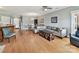Cozy living room with hardwood floors, seating, and an open layout to the dining area and kitchen at 930 Jetton St, Davidson, NC 28036