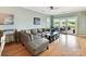 Bright living room with a comfortable sectional sofa, hardwood floors and lots of natural light through sliding glass doors at 930 Jetton St, Davidson, NC 28036