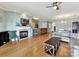 Open-concept living room featuring a fireplace, hardwood floors, and seamless transition to the kitchen area at 930 Jetton St, Davidson, NC 28036